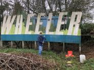 Cleaning the Wheeler sign